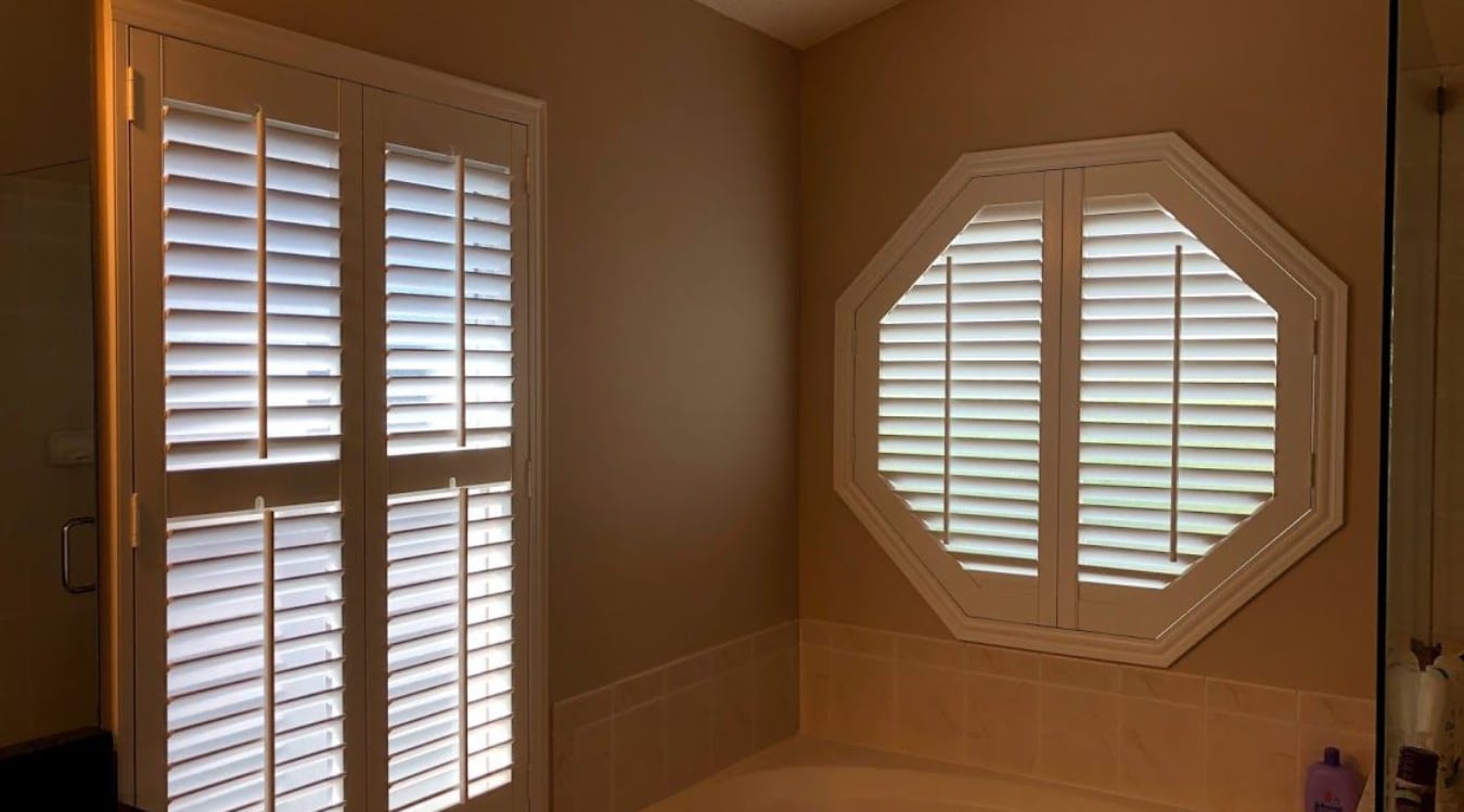 Octagon window with plantation shutters.